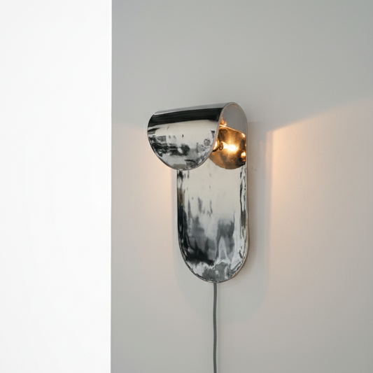 Modern wall lamp with metallic finish on a neutral background