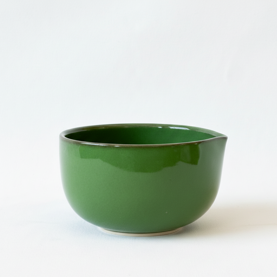 Green ceramic bowl on a white background